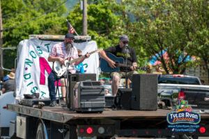 Nostalgic Distortion performing on the back of a flatbed truck in Gorham NH as part of the main parade for the 2024 July 4th Spectacular celebration.